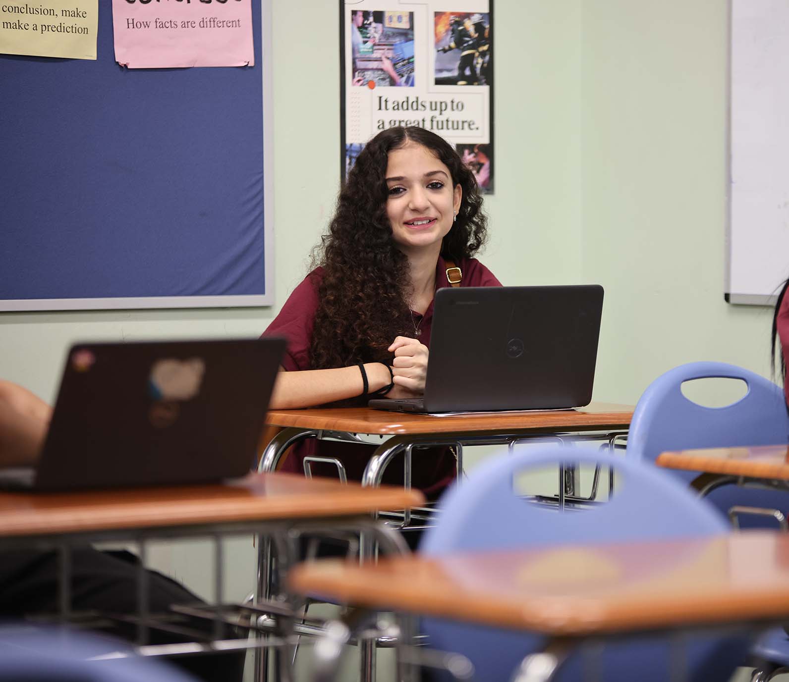 GSA St. Louis Middle student wearing headphones uses a laptop in class